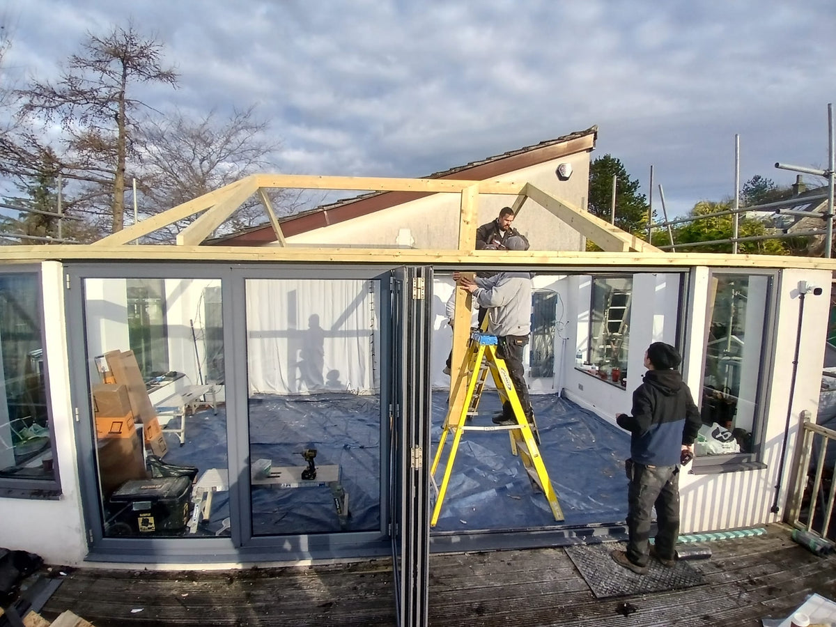 A house with a new tiled conservatory roof, seen from the garden
