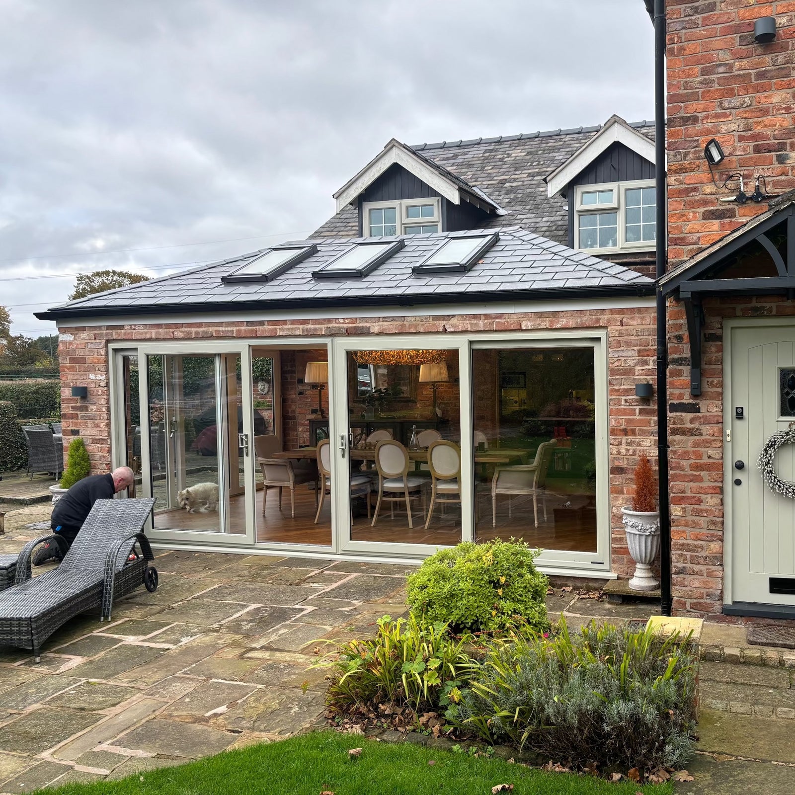 A completed conservatory roof conversion with a tiled roof and rooflights