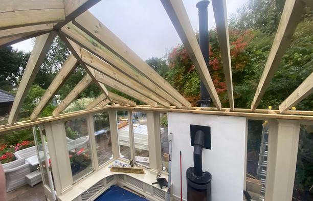 C24 timber rafters being built on site over a conservatory, before the insulation and deck go on