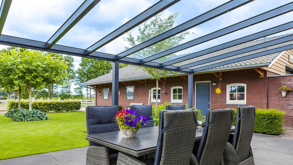 Outdoor patio with table, chairs, and a covered area in a residential setting.