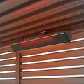 Nova Zesti 3000W pergola heater mounted beneath pergola louvres, element glowing red