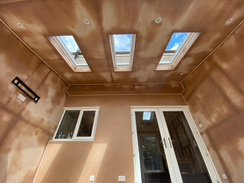 Plastered ceiling with three rooflights