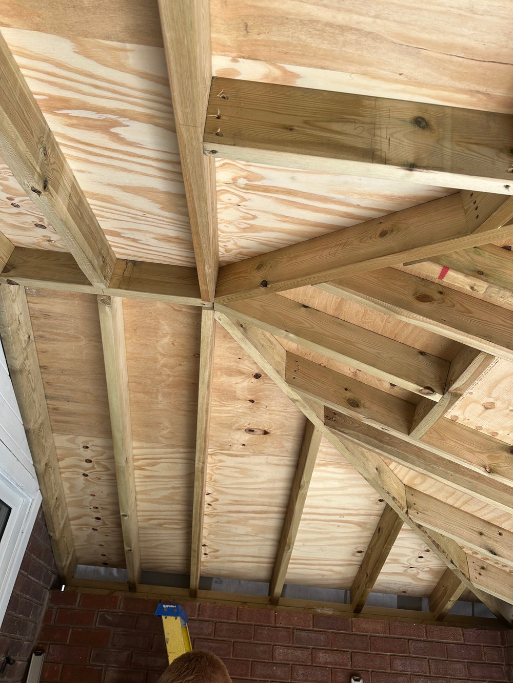 Timber roof structure over the new wall