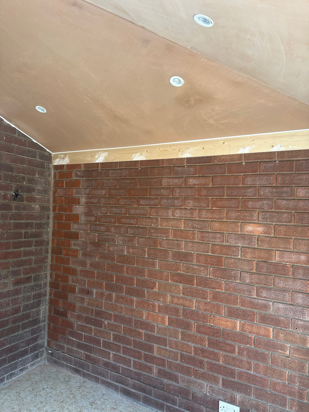 Plastered ceiling and new brick wall