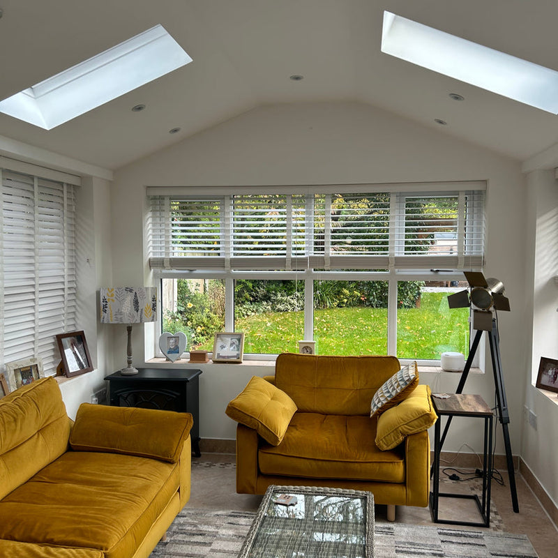 The same conservatory after conversion, with a plastered ceiling and rooflights